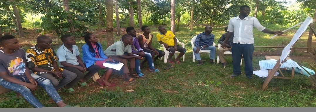A male facilitator taking through young parents the role and advantages of male involvement in child care 